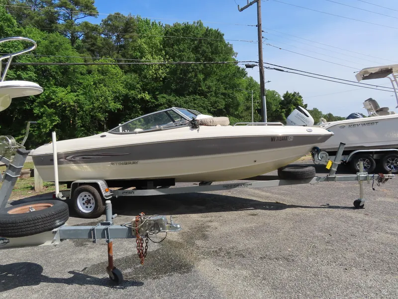 Slide: The Image of 2013 Stingray 195LX boat on a trailer in a parking lot. - 6