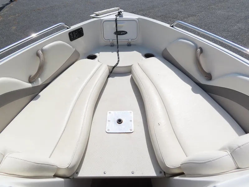 Slide: The Image of 2013 Stingray 195LX boat bow seating area with white upholstery. - 9