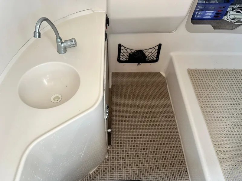 Slide: The Image of 2003 Hurricane 26 SD boat interior with sink and storage net. - 11
