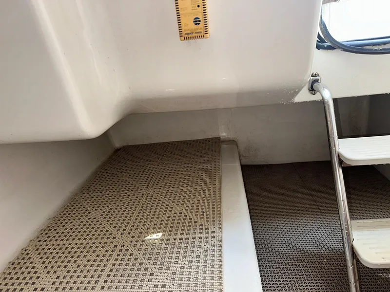 Slide: The Image of Interior of 2003 Hurricane 26 SD boat showing steps and flooring. - 15