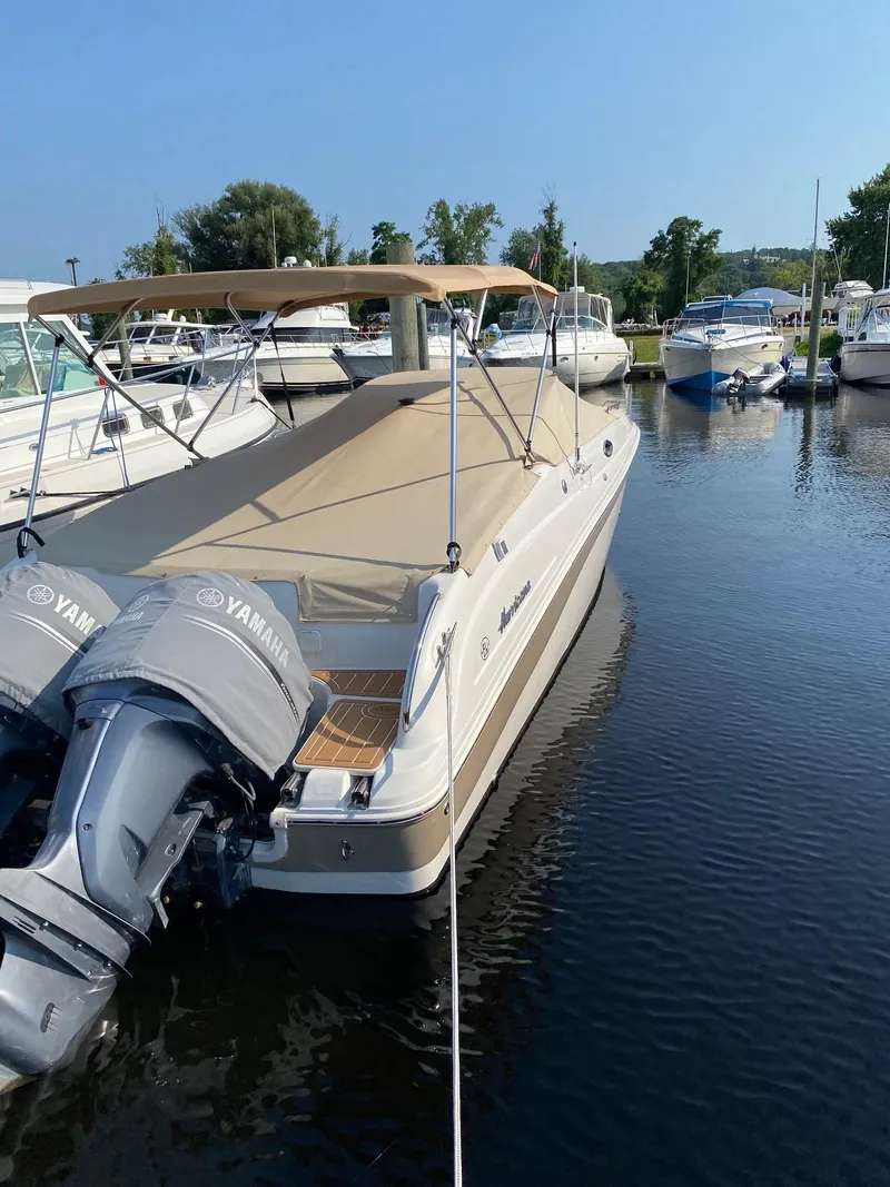Slide: The Image of 2003 Hurricane 26 SD boat docked with twin Yamaha outboard motors. - 17