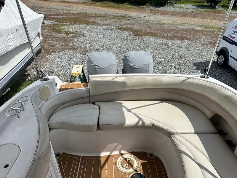 Slide: The Image of 2003 Hurricane 26 SD boat interior with curved seating and cup holders. - 21