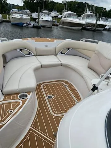 Slide: The Image of 2003 Hurricane 26 SD boat with spacious seating and teak-style flooring docked at a marina. - 22