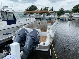 Slide: The Image of 2003 Hurricane 26 SD boat docked with twin outboard motors. - 24