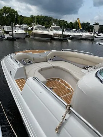 Slide: The Image of 2003 Hurricane 26 SD boat with spacious seating docked at a marina. - 27