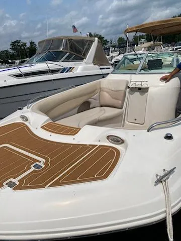 Slide: The Image of 2003 Hurricane 26 SD boat with spacious seating docked at a marina. - 28