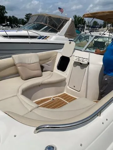 Slide: The Image of 2003 Hurricane 26 SD boat with spacious seating and modern amenities at a marina. - 30