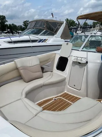 Slide: The Image of 2003 Hurricane 26 SD boat with white seating and storage compartment. - 32