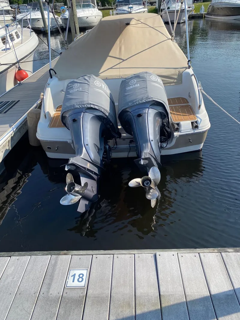 Slide: The Image of 2003 Hurricane 26 SD boat with twin Yamaha outboard engines docked at marina. - 33