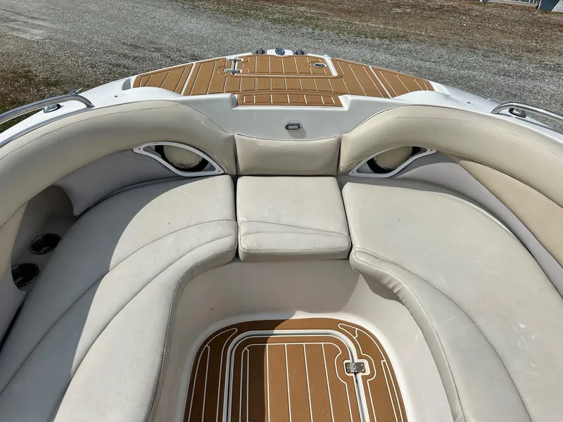 Slide: The Image of 2003 Hurricane 26 SD boat interior with beige seating and wood-patterned flooring. - 34