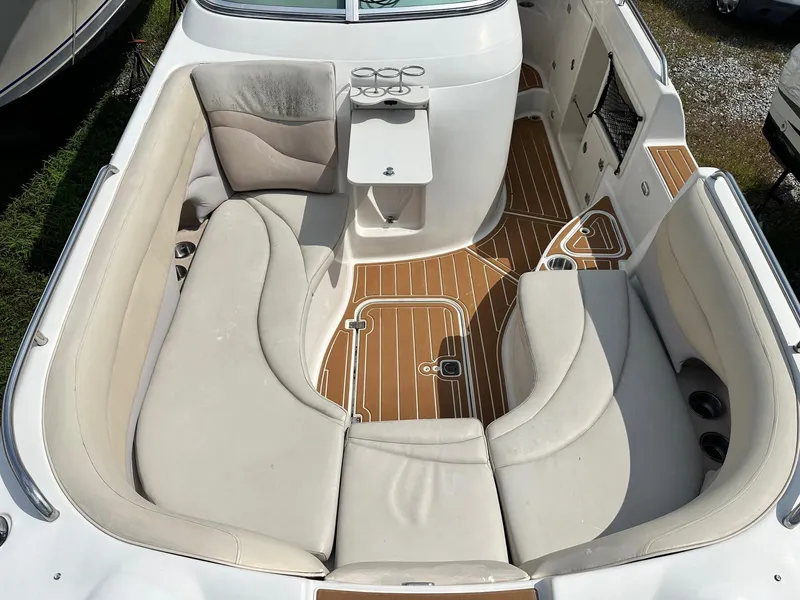 Slide: The Image of 2003 Hurricane 26 SD boat interior with beige seating and wood-patterned flooring. - 35