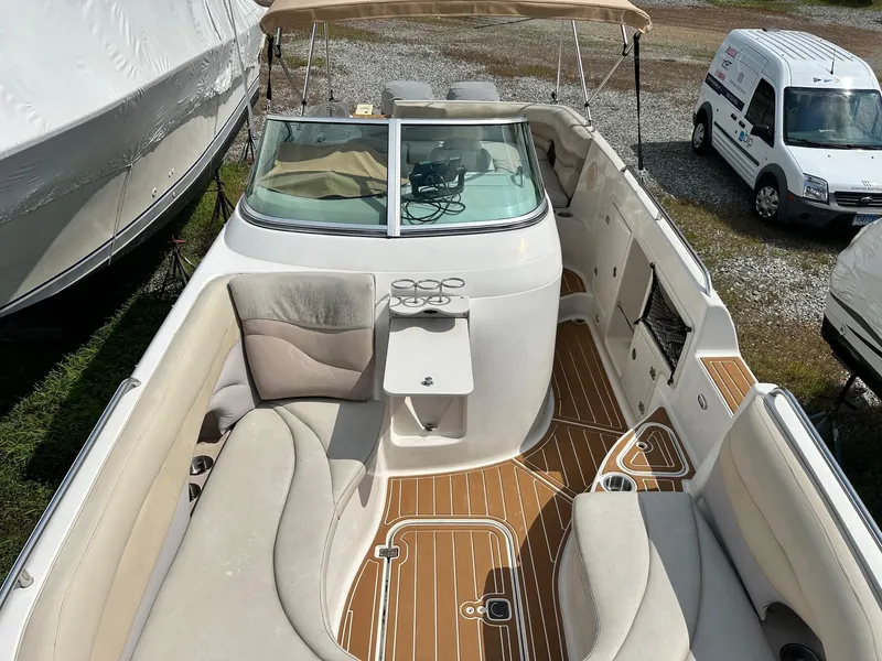 Slide: The Image of 2003 Hurricane 26 SD boat interior with seating and wood-patterned flooring. - 36