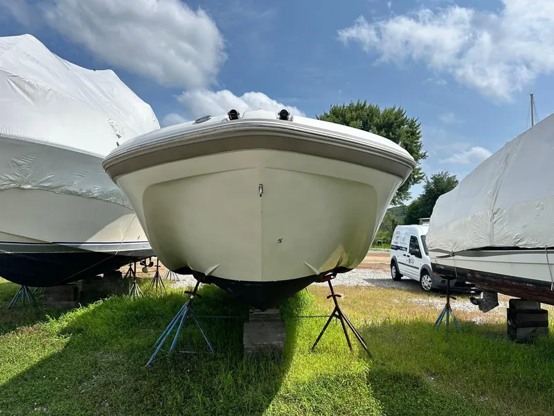 Slide: The Image of 2003 Hurricane 26 SD boat on stands, outdoor storage, sunny day. - 4