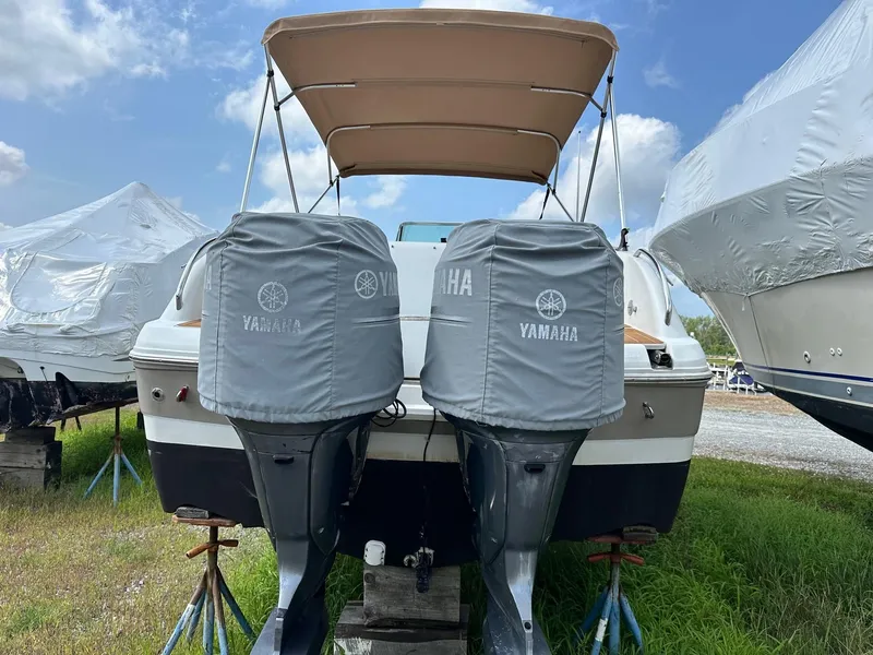 Slide: The Image of 2003 Hurricane 26 SD boat with Yamaha engines, covered and stored outdoors. - 6