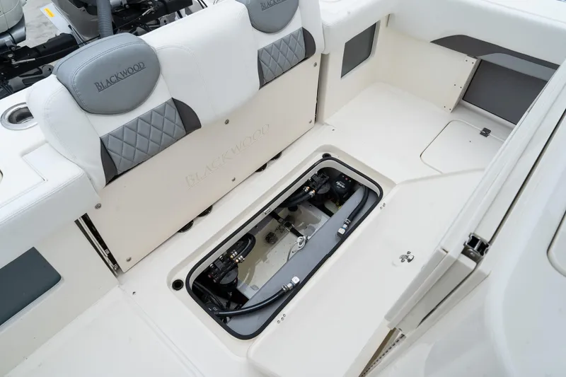 Slide: The Image of 2025 Blackwood 290 OPEN boat interior with storage compartment open. - 18