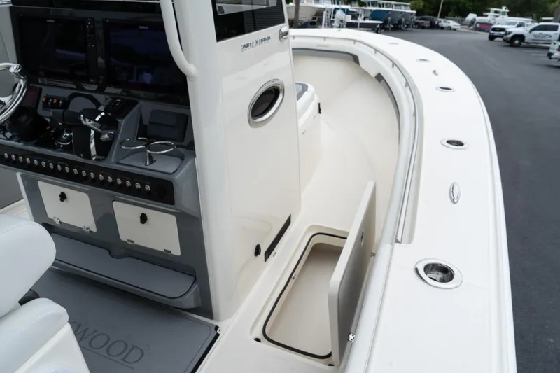 Slide: The Image of 2025 Blackwood 290 OPEN boat interior with storage compartment and control panel. - 22