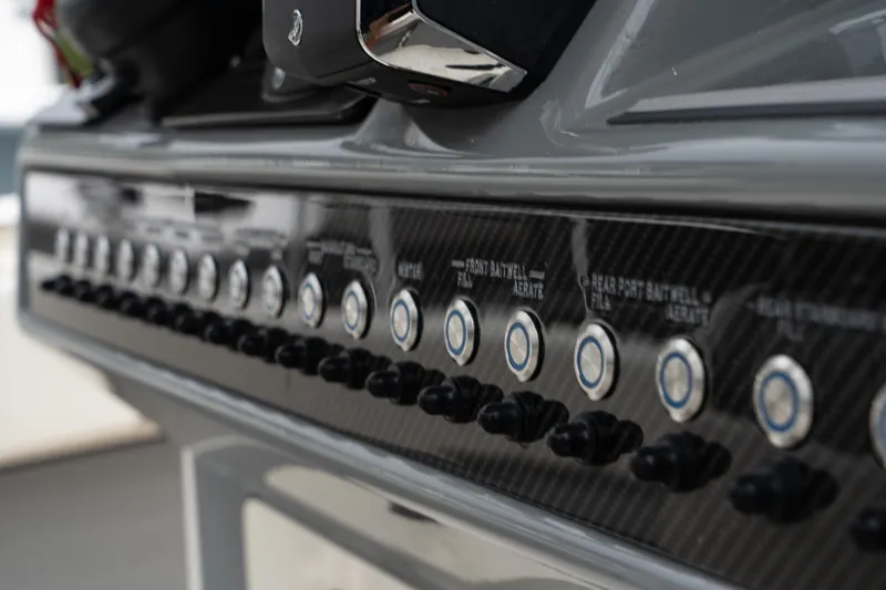 Slide: The Image of Control panel of the 2025 Blackwood 290 OPEN boat with multiple switches and buttons. - 25