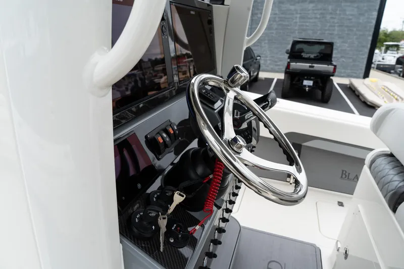 Slide: The Image of 2025 Blackwood 290 OPEN boat steering console with modern controls and chrome wheel. - 30