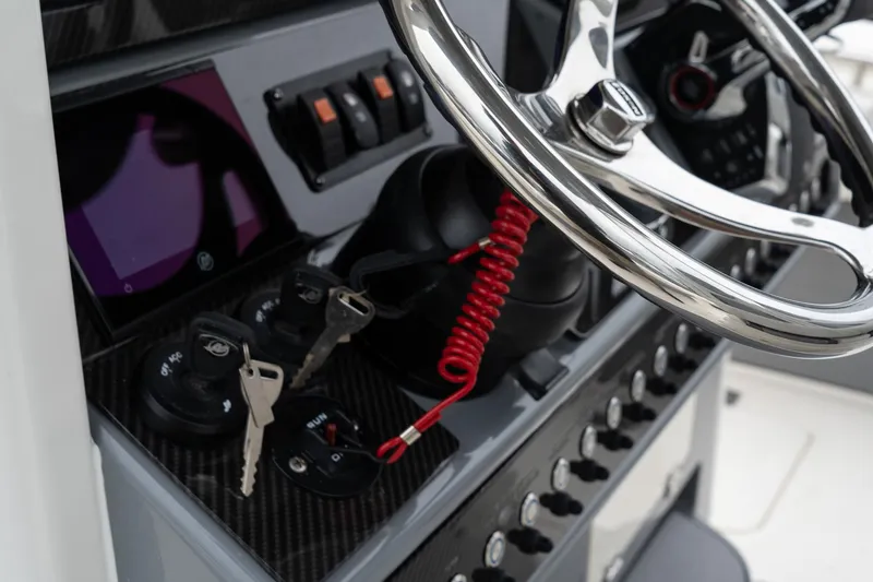Slide: The Image of Close-up of 2025 Blackwood 290 OPEN boat dashboard with steering wheel and ignition keys. - 31