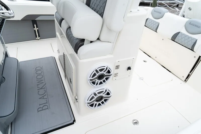 Slide: The Image of 2025 Blackwood 290 OPEN boat interior with cushioned seating and built-in speakers. - 32