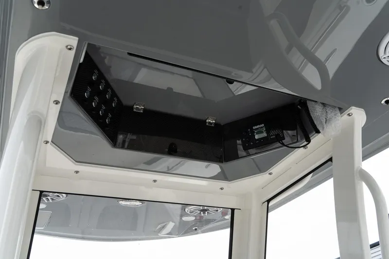 Slide: The Image of 2025 Blackwood 290 OPEN boat console with electronic controls and storage. - 38