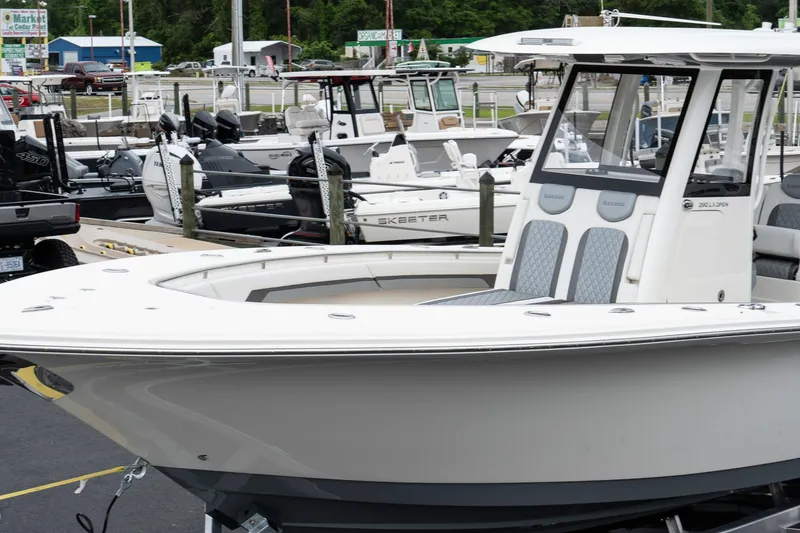 Slide: The Image of 2025 Blackwood 290 OPEN boat displayed at a marina with other boats in the background. - 4