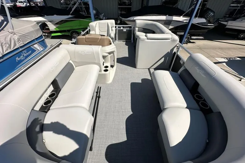 Slide: The Image of 2024 SunChaser Vista 18 LR pontoon boat interior with plush seating and steering wheel. - 5