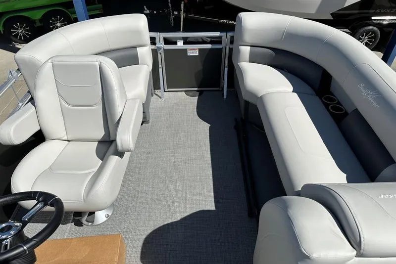 Slide: The Image of 2024 SunChaser Vista 18 LR pontoon boat interior with plush seating and modern helm. - 6