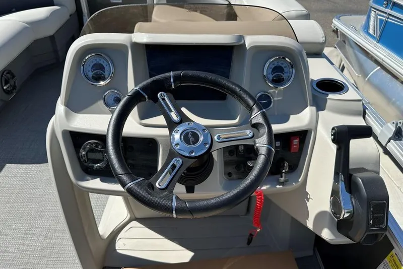 Slide: The Image of 2024 SunChaser Vista 18 LR pontoon boat interior with gray seating and cup holders. - 8