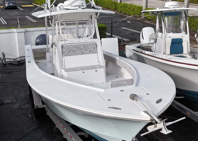 Slide: The Image of 2005 Regulator 32 Forward Seating boat with Garmin electronics, docked on a trailer. - 11