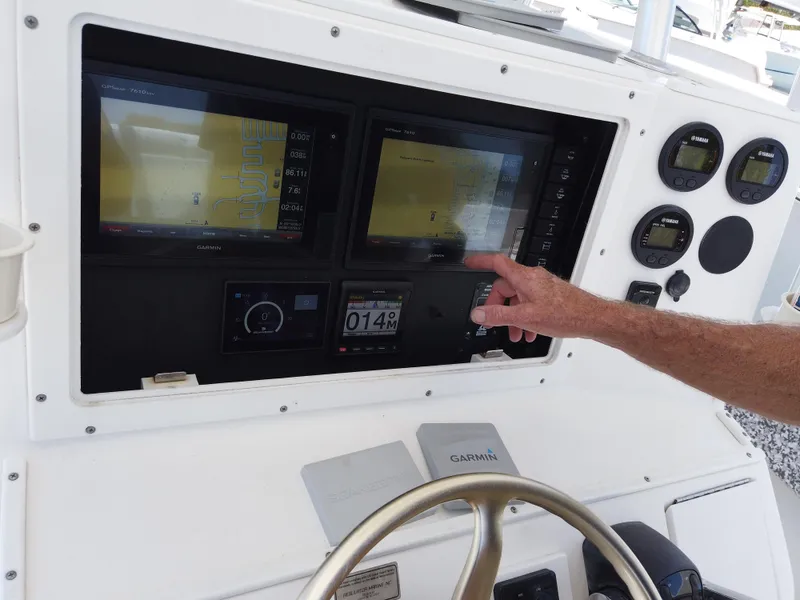 Slide: The Image of Control panel of a 2005 Regulator 32 Forward Seating boat with Garmin navigation displays. - 12