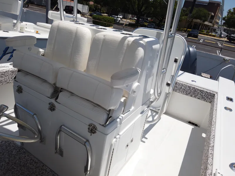 Slide: The Image of 2005 Regulator 32 Forward Seating boat interior with white cushioned seats. - 19
