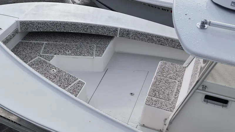 Slide: The Image of 2005 Regulator 32 Forward Seating boat with cushioned seating and storage compartments. - 28