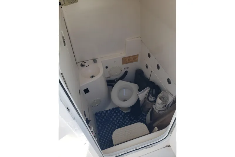 Slide: The Image of 2005 Regulator 32 Forward Seating boat interior with compact marine toilet and sink. - 39