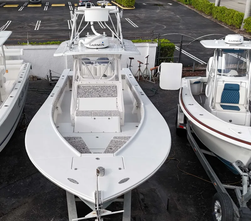 Slide: The Image of 2005 Regulator 32 Forward Seating boat with Garmin electronics, docked between two other boats. - 4