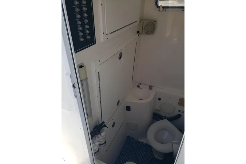 Slide: The Image of 2005 Regulator 32 Forward Seating boat interior with compact bathroom amenities. - 40