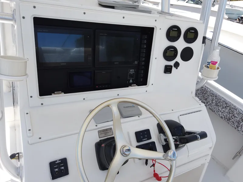 Slide: The Image of 2005 Regulator 32 Forward Seating boat helm with steering wheel and navigation instruments. - 7