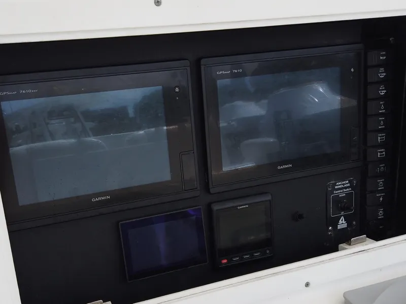 Slide: The Image of Control panel of a 2005 Regulator 32 Forward Seating boat with Garmin displays. - 8