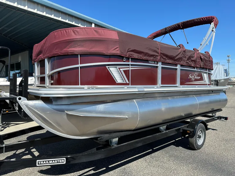 The Image of 2024 SunChaser Vista 18 LR pontoon boat on a Trailmaster trailer. - 0