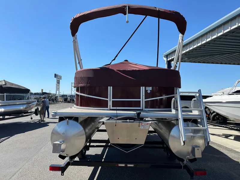 Slide: The Image of 2024 SunChaser Vista 18 LR pontoon boat with maroon canopy, rear view. - 3