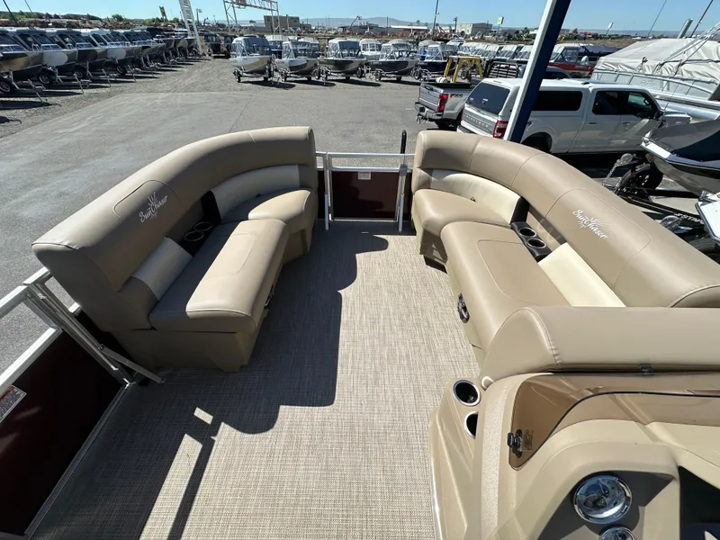 Slide: The Image of 2024 SunChaser Vista 18 LR pontoon boat with beige seating and spacious deck. - 6
