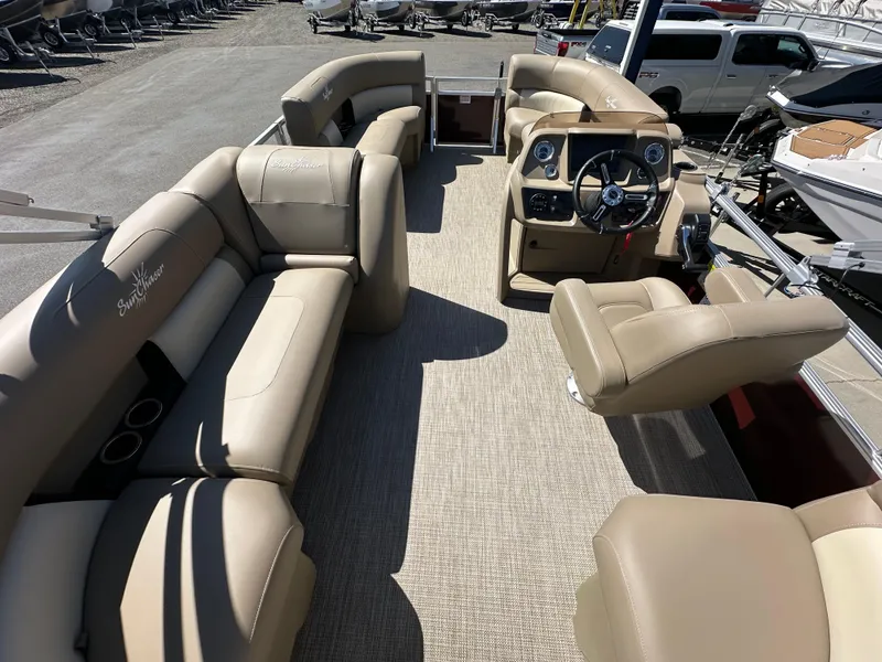 Slide: The Image of 2024 SunChaser Vista 18 LR pontoon boat interior with beige seating and steering console. - 7