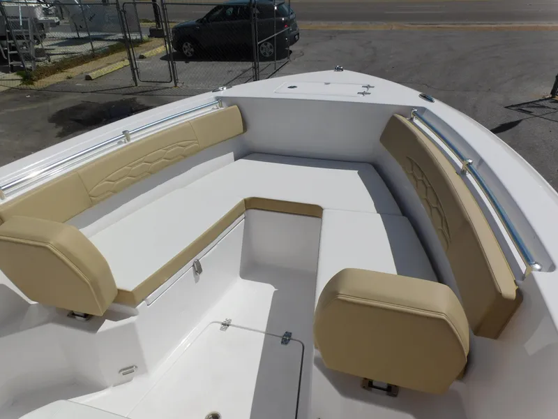 Slide: The Image of 2024 Aquasport 2200 Center Console boat with beige cushioned seating. - 10