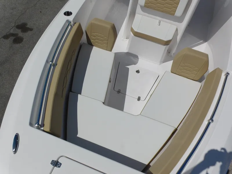 Slide: The Image of 2024 Aquasport 2200 Center Console boat with tan and white seating. - 13