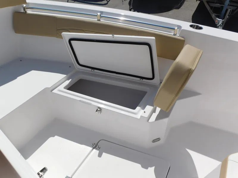 Slide: The Image of 2024 Aquasport 2200 Center Console boat with open storage compartment. - 15