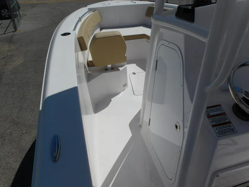 Slide: The Image of 2024 Aquasport 2200 Center Console boat interior with seating and storage. - 17