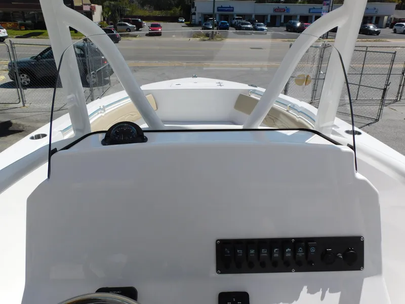 Slide: The Image of 2024 Aquasport 2200 Center Console boat dashboard and controls. - 24