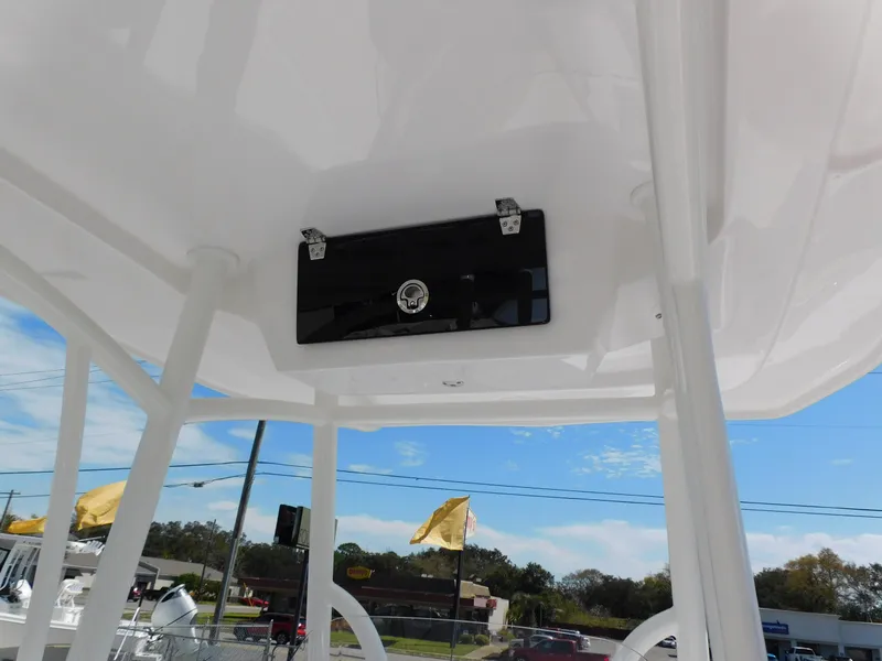 Slide: The Image of 2024 Aquasport 2200 Center Console T-top with storage compartment. - 25