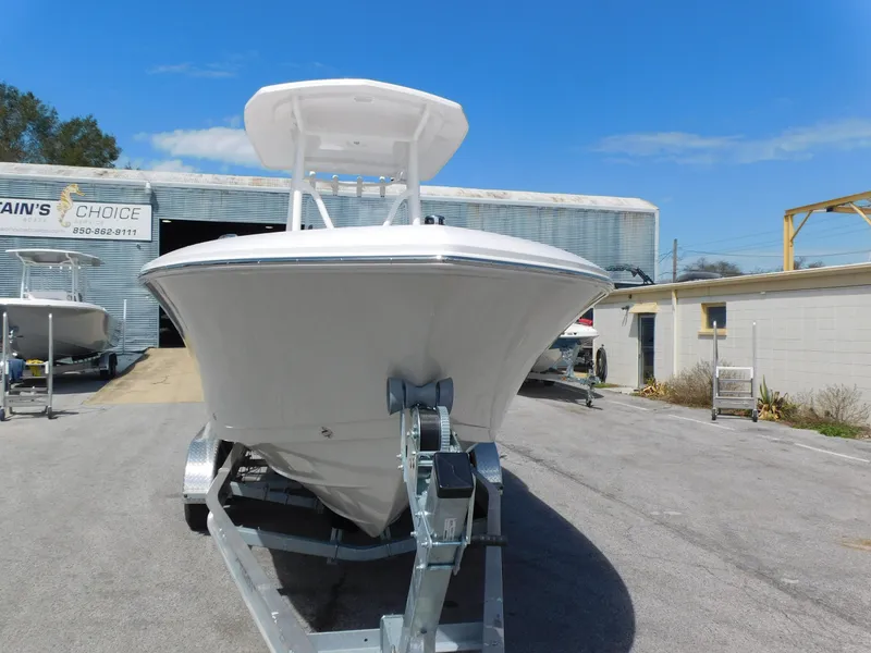 Slide: The Image of 2024 Aquasport 2200 Center Console boat on trailer in front of a warehouse. - 3