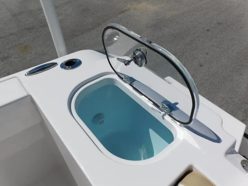 Slide: The Image of 2024 Aquasport 2200 Center Console livewell with open lid. - 32